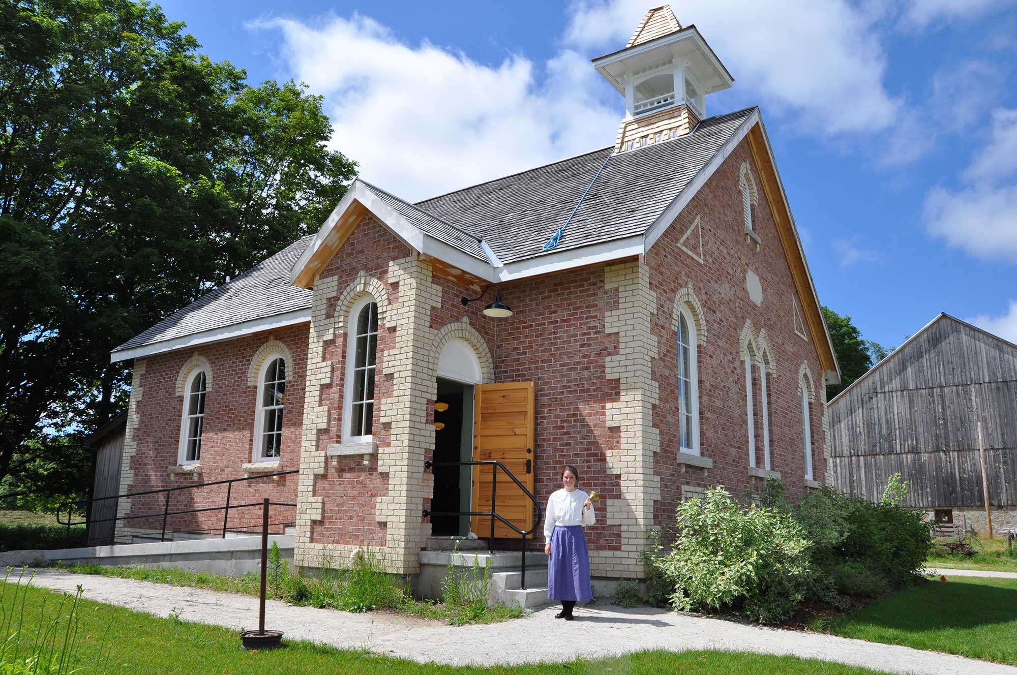 1920s Schoolhouse with a cloudy blue sky