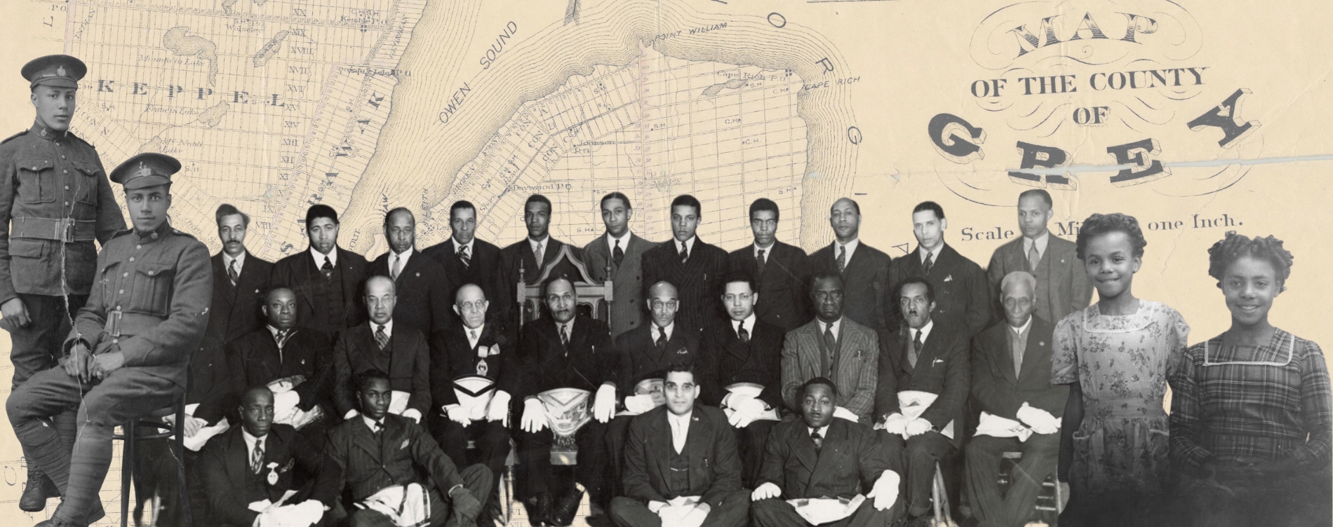 Composite image featuring a large group of people posed in formal attire and military uniforms, arranged in rows. The background is an old map labeled “Map of the County of Grey,” showing geographic details including Owen Sound and Keppel. The map text includes “Scale 1 Mile to One Inch.”