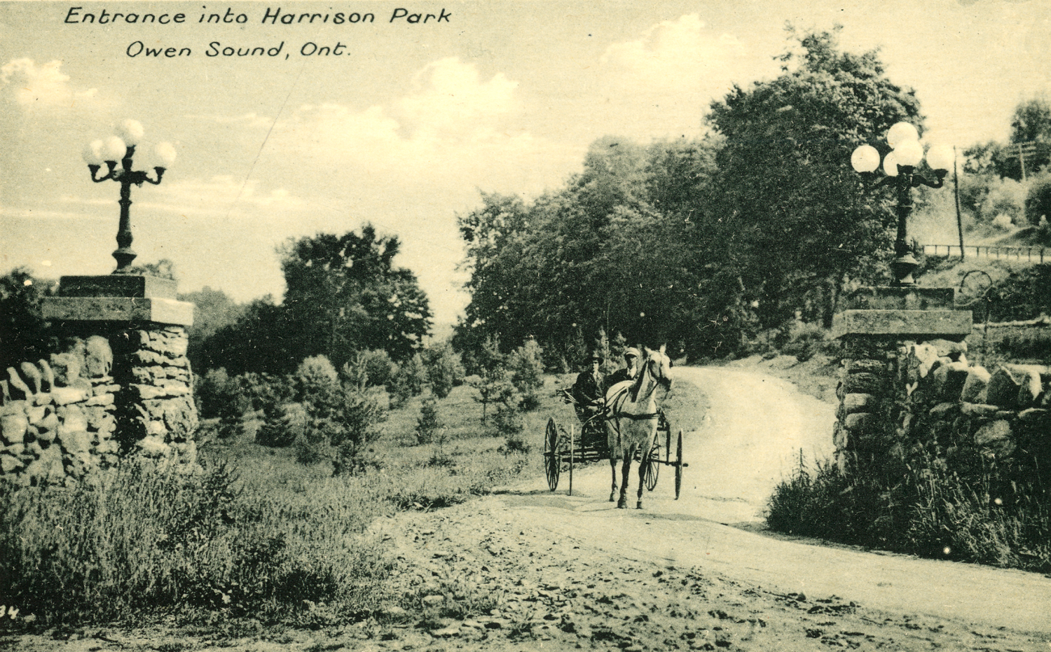 A horse drawn carriage exiting Harrison Park.