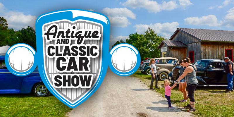 Outdoor scene with blue sky and clouds. People admire several classic cars. Logo for Antique and Classic Car Show superimposed above.