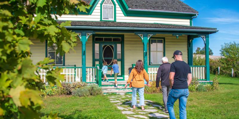 A family walks toward a farmhouse.