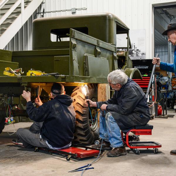 Vehicle restoration volunteers working on a 1943 1500CWT army truck.