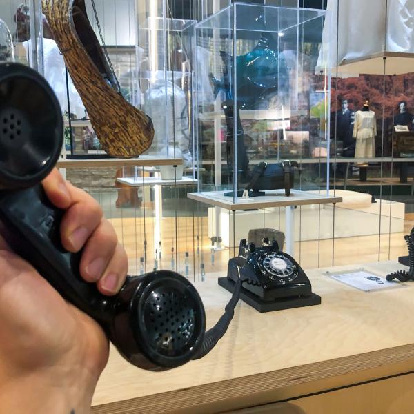 A headset lifted off the cradle of a rotary phone - part of the Voices of Grey exhibit.